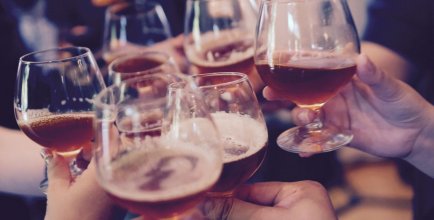 family raising a glass (we see just hands)